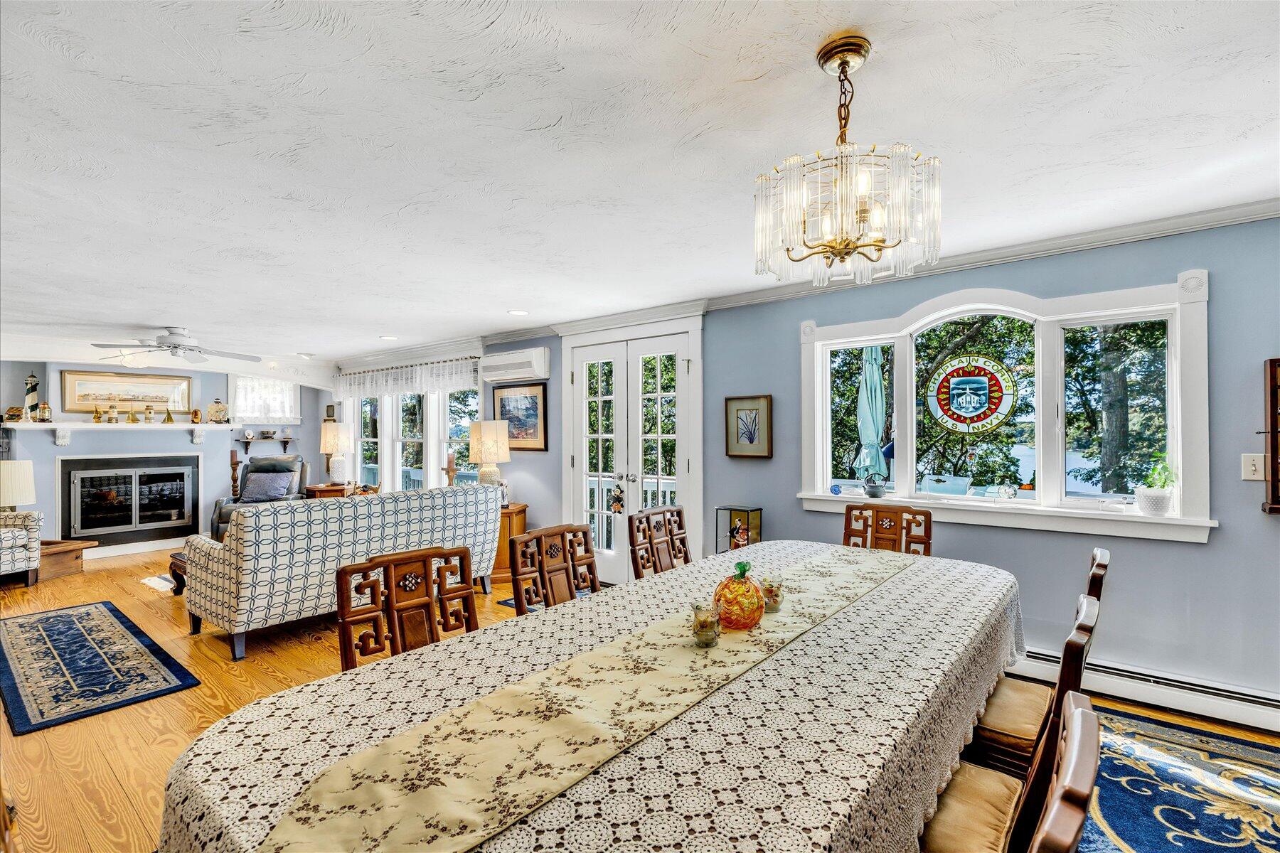 248 Wheeler Road Mashpee, MA 02649 - Photo 18 of 76 a view of a dining room with furniture a chandelier and wooden floor