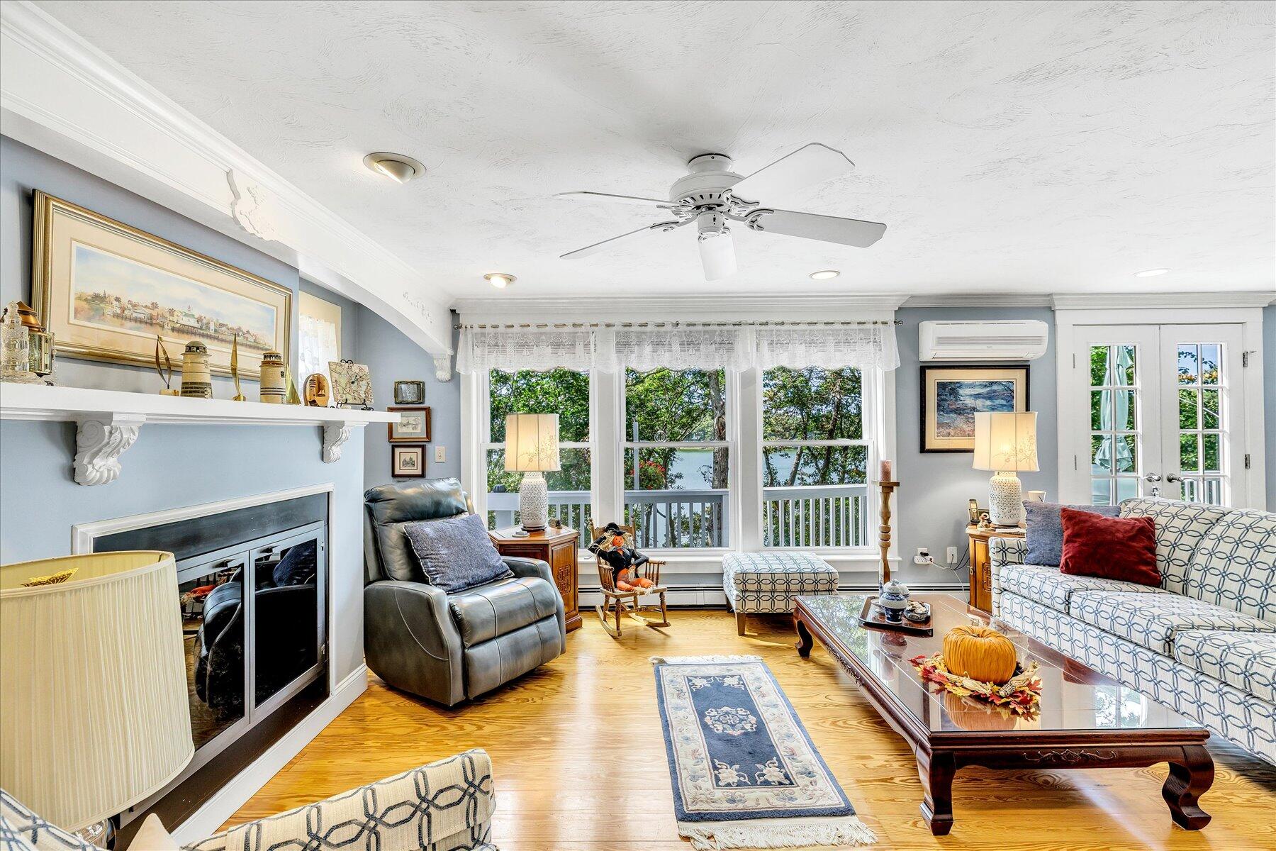 248 Wheeler Road Mashpee, MA 02649 - Photo 21 of 76 a living room with furniture fireplace and a large window