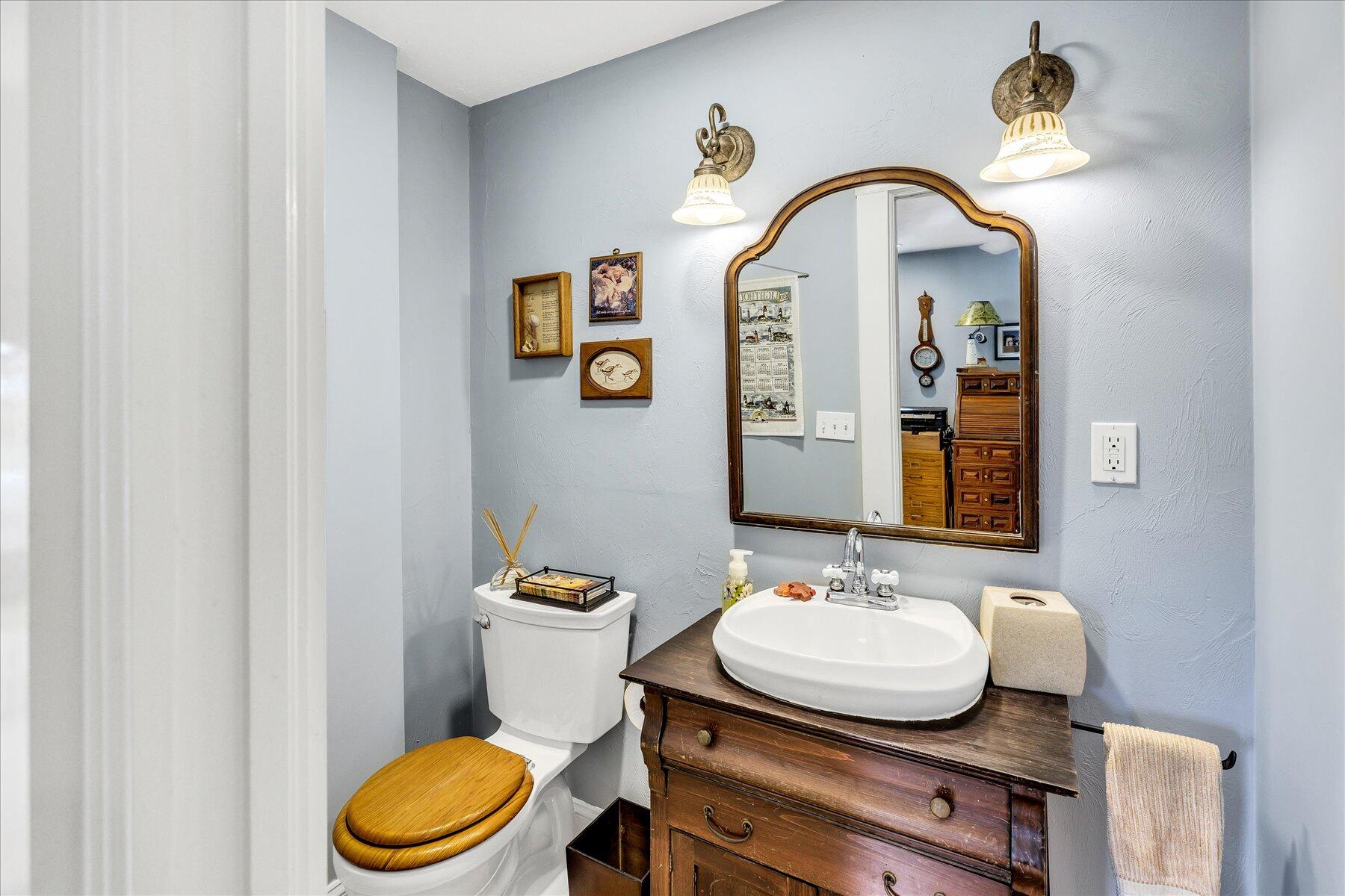 248 Wheeler Road Mashpee, MA 02649 - Photo 25 of 76 a bathroom with a granite countertop toilet a sink and a mirror