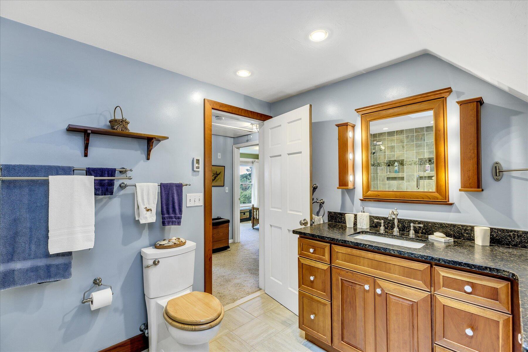 248 Wheeler Road Mashpee, MA 02649 - Photo 34 of 76 a spacious bathroom with a double vanity sink a mirror and a toilet