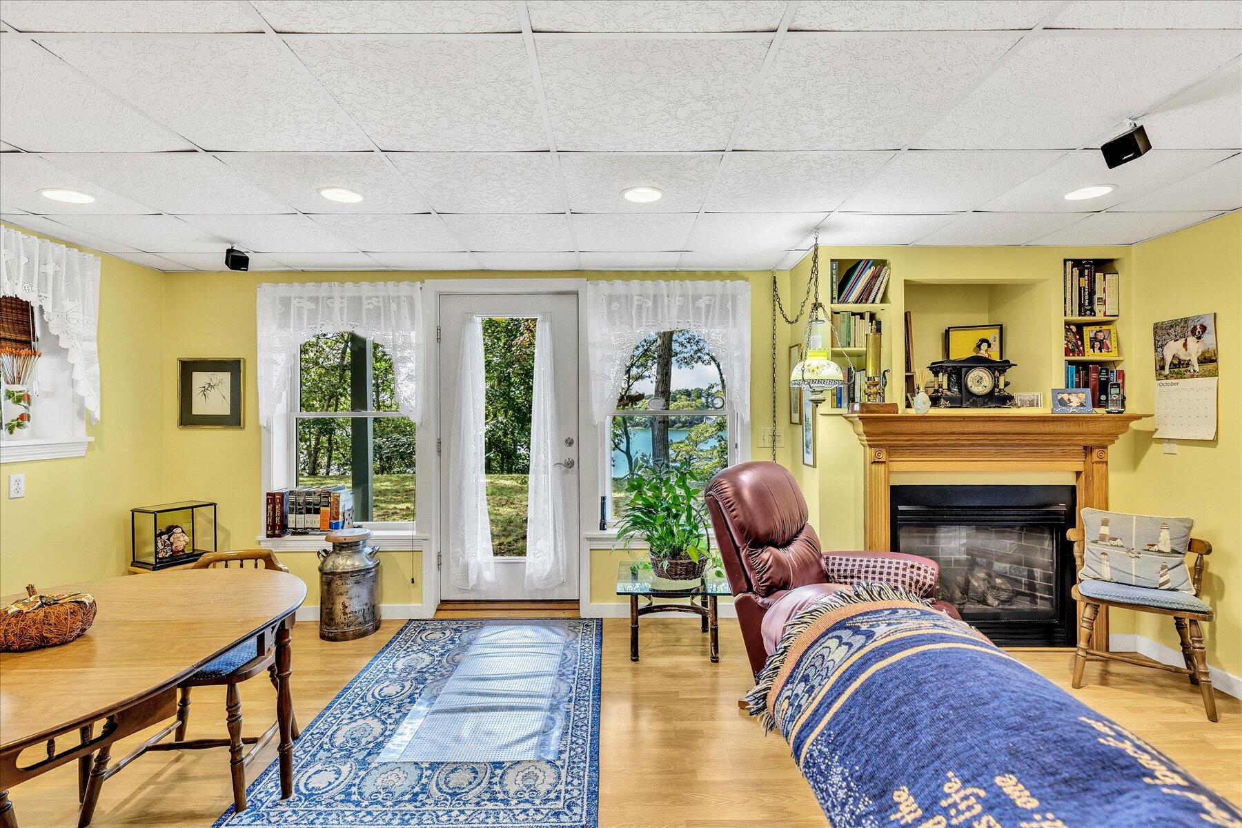 248 Wheeler Road Mashpee, MA 02649 - Photo 43 of 76 a living room with furniture fireplace and a table