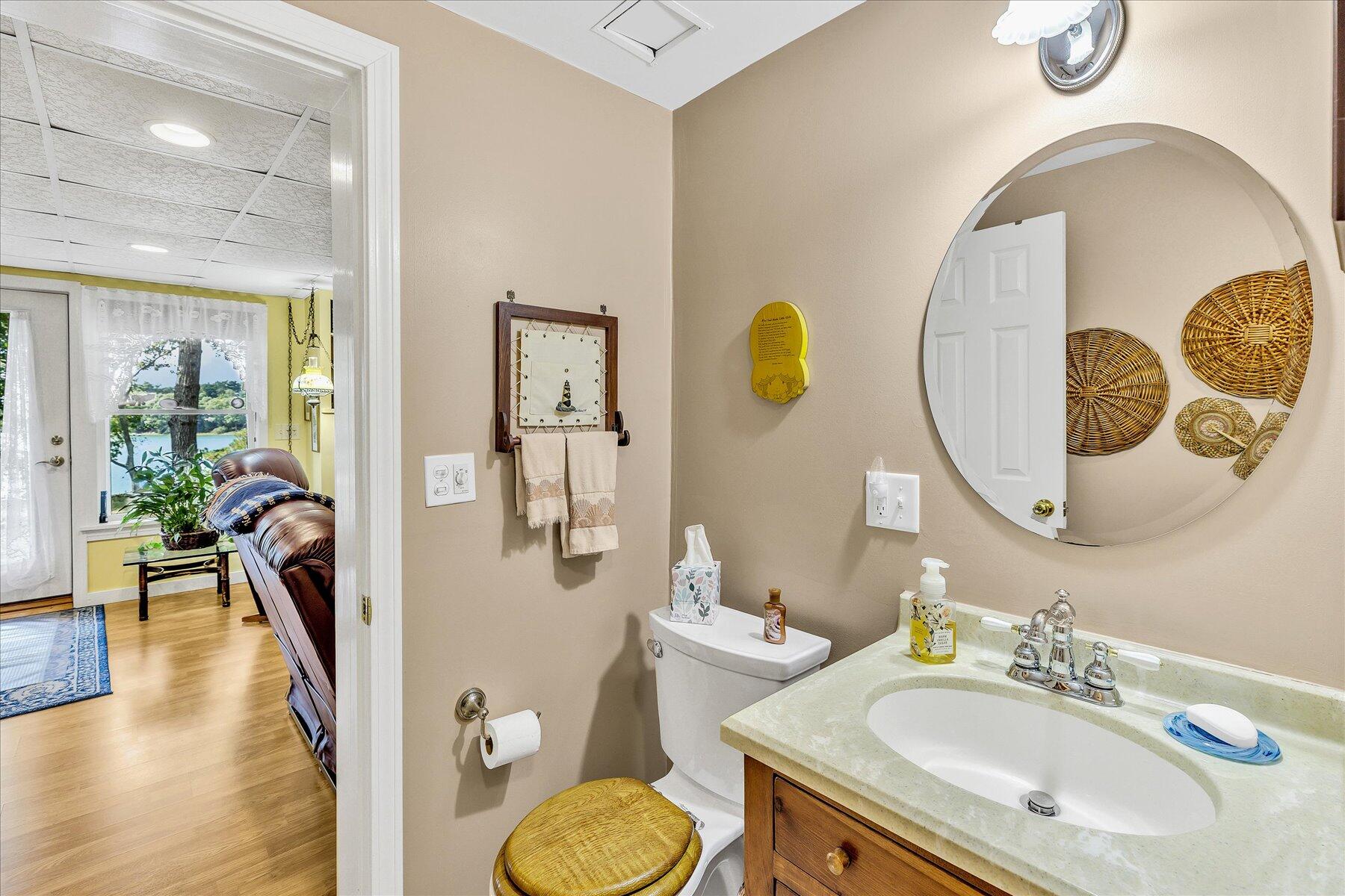 248 Wheeler Road Mashpee, MA 02649 - Photo 45 of 76 a bathroom with a granite countertop sink mirror and vanity