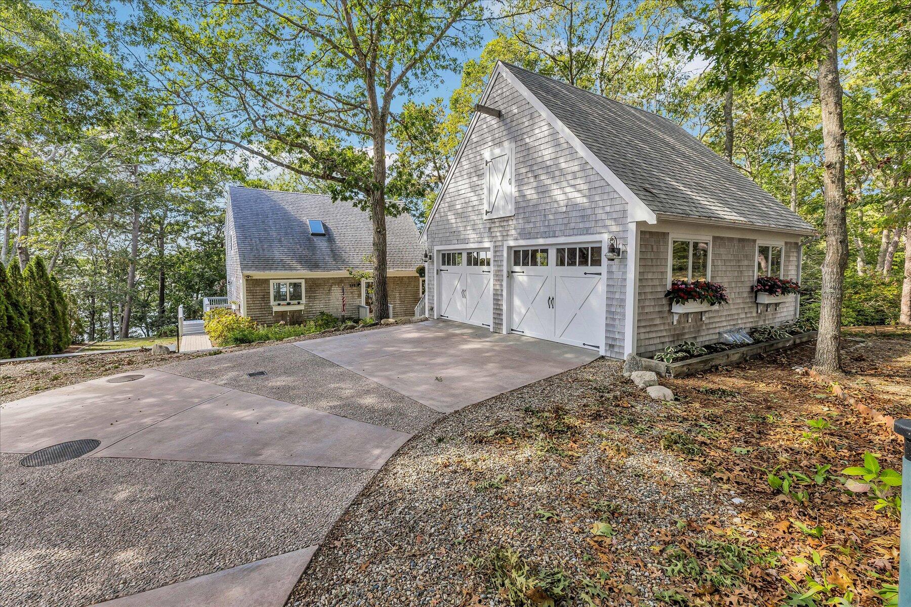 248 Wheeler Road Mashpee, MA 02649 - Photo 6 of 76 a view of a house with a yard covered in snow