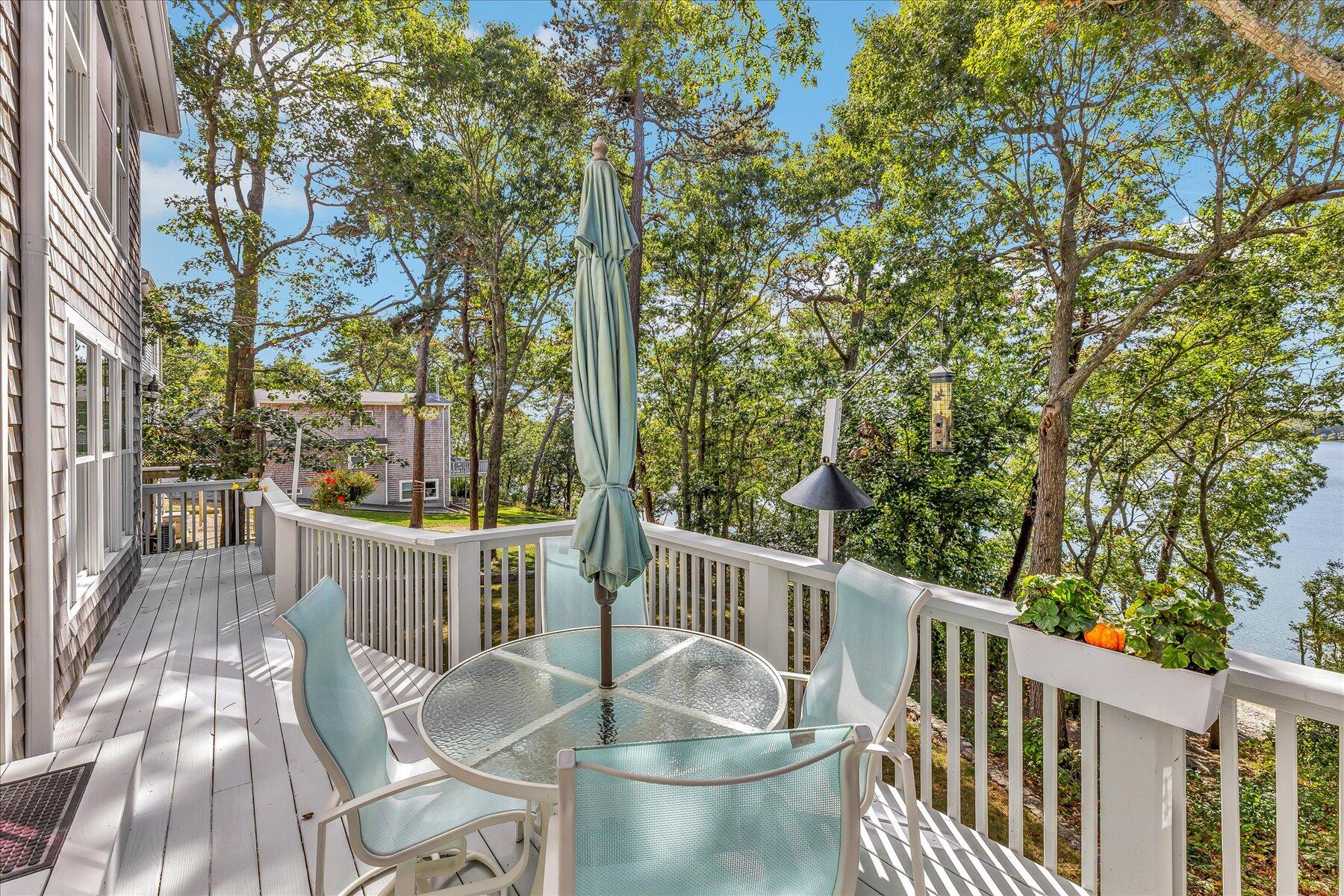 248 Wheeler Road Mashpee, MA 02649 - Photo 65 of 76 a view of a chair and table in the deck