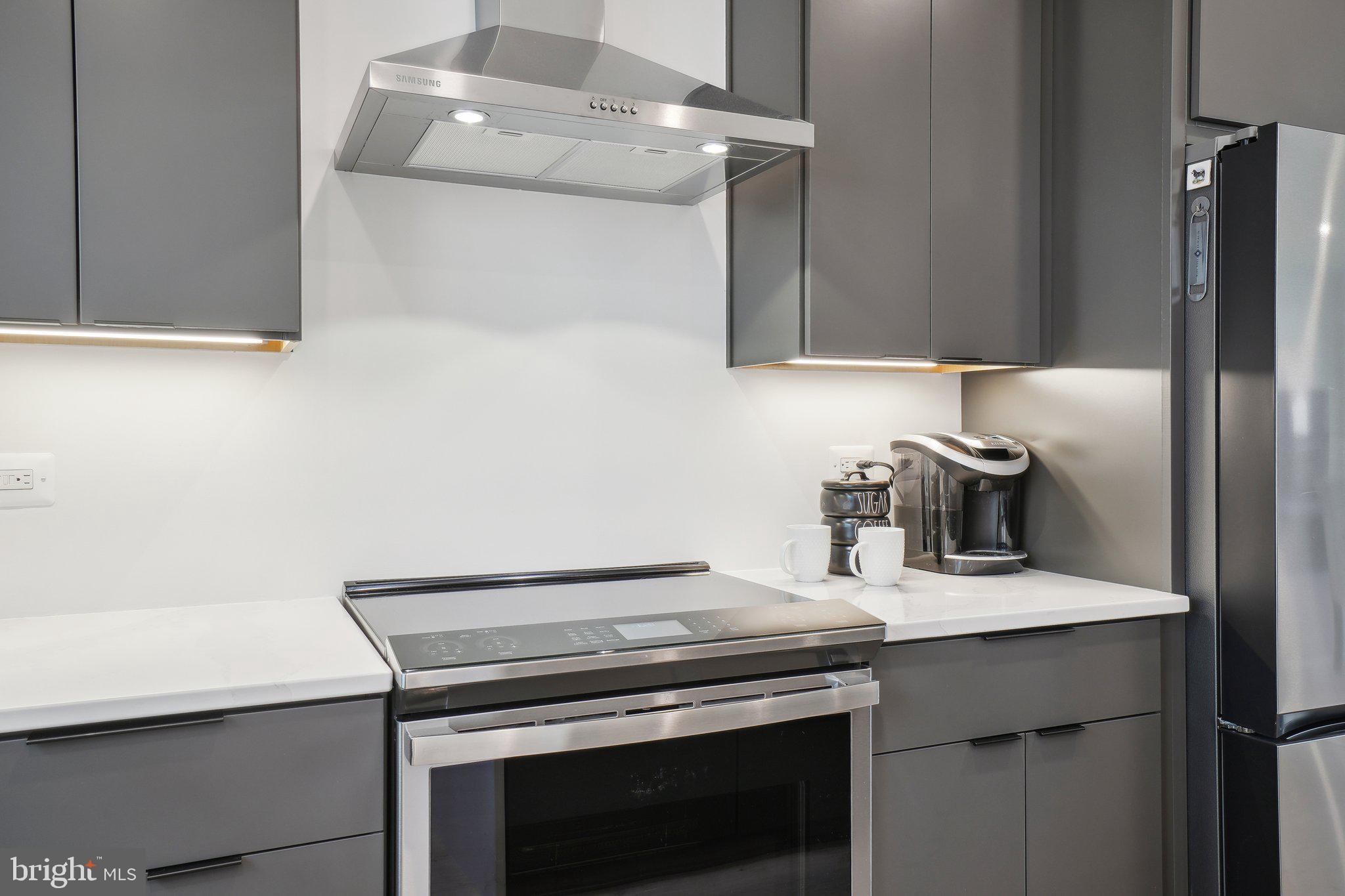 2138 Tysons Ridgeline Road Falls Church, VA 22043 - Photo 6 of 35 a kitchen with a stove and a refrigerator
