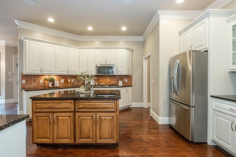 3505 Watson Road Cumming, GA 30028 - Photo 28 of 88 a kitchen with stainless steel appliances granite countertop a refrigerator and a stove