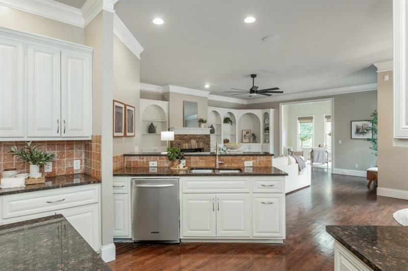 3505 Watson Road Cumming, GA 30028 - Photo 29 of 88 a kitchen with stainless steel appliances granite countertop a stove and white cabinets