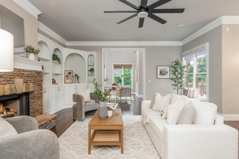 3505 Watson Road Cumming, GA 30028 - Photo 34 of 88 a living room with furniture a fireplace and a large window