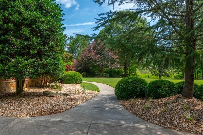 3505 Watson Road Cumming, GA 30028 - Photo 4 of 88 a view of a garden with a fountain