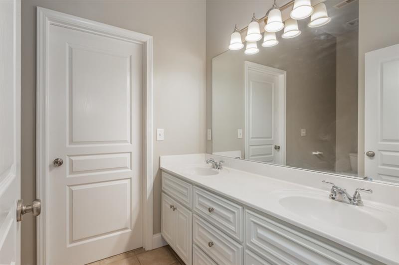 3505 Watson Road Cumming, GA 30028 - Photo 57 of 88 a bathroom with a sink and a mirror