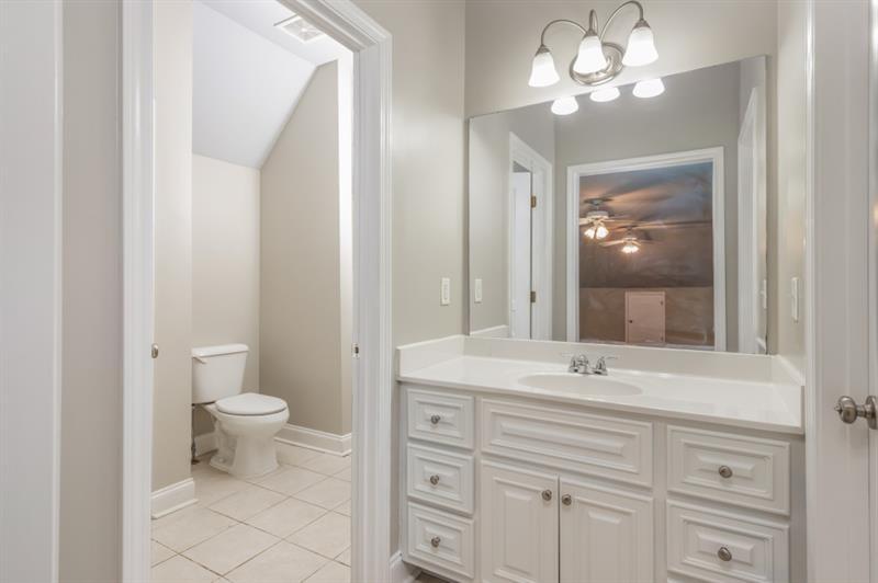 3505 Watson Road Cumming, GA 30028 - Photo 64 of 88 a bathroom with a sink a toilet and a large mirror