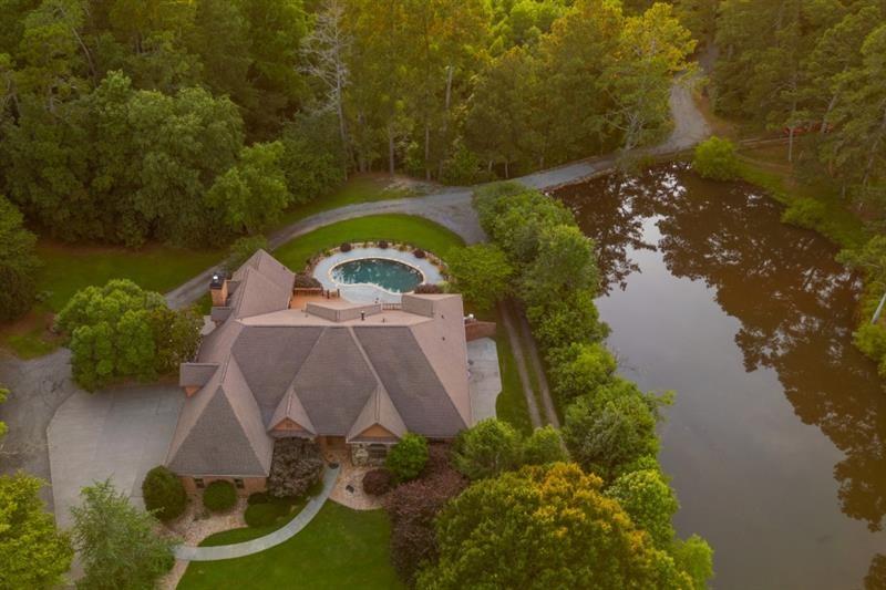3505 Watson Road Cumming, GA 30028 - Photo 81 of 88 an aerial view of a house with outdoor space and a lake view