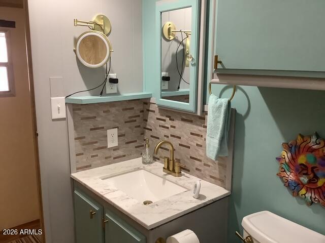 2605 South Tomahawk Road, Unit 10 Apache Junction, AZ 85119 - Photo 12 of 22 a bathroom with a sink toilet and a mirror