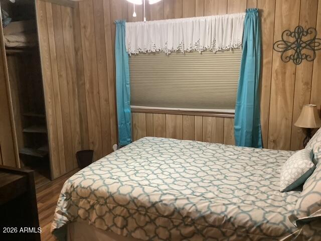 2605 South Tomahawk Road, Unit 10 Apache Junction, AZ 85119 - Photo 14 of 22 a bed sitting in a bedroom next to a small yard