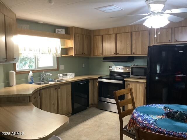 2605 South Tomahawk Road, Unit 10 Apache Junction, AZ 85119 - Photo 3 of 22 a kitchen with a sink appliances and cabinets