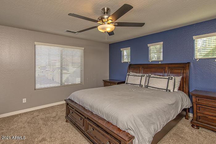 1941 West Davis Road Phoenix, AZ 85023 - Photo 12 of 24 a bedroom with a bed and a chandelier