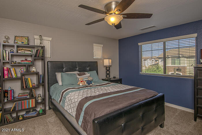 1941 West Davis Road Phoenix, AZ 85023 - Photo 14 of 24 a bedroom with a bed bookshelf and a window