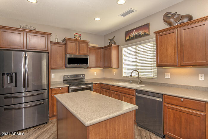 1941 West Davis Road Phoenix, AZ 85023 - Photo 2 of 24 a kitchen with stainless steel appliances granite countertop a refrigerator stove microwave and sink