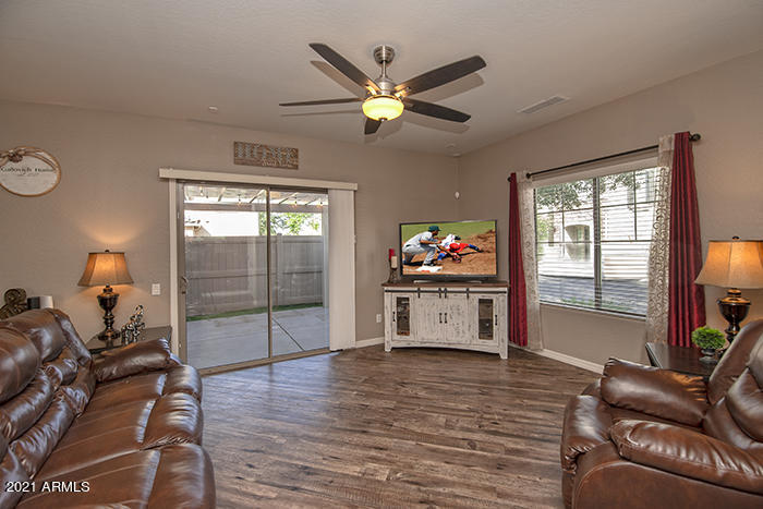 1941 West Davis Road Phoenix, AZ 85023 - Photo 5 of 24 a living room with furniture a chandelier and a window