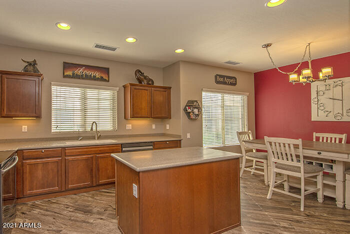 1941 West Davis Road Phoenix, AZ 85023 - Photo 7 of 24 a kitchen that has a sink a table and chairs in it