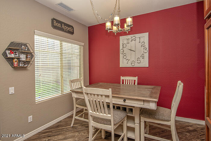 1941 West Davis Road Phoenix, AZ 85023 - Photo 9 of 24 a view of a dining room with furniture window and wooden floor