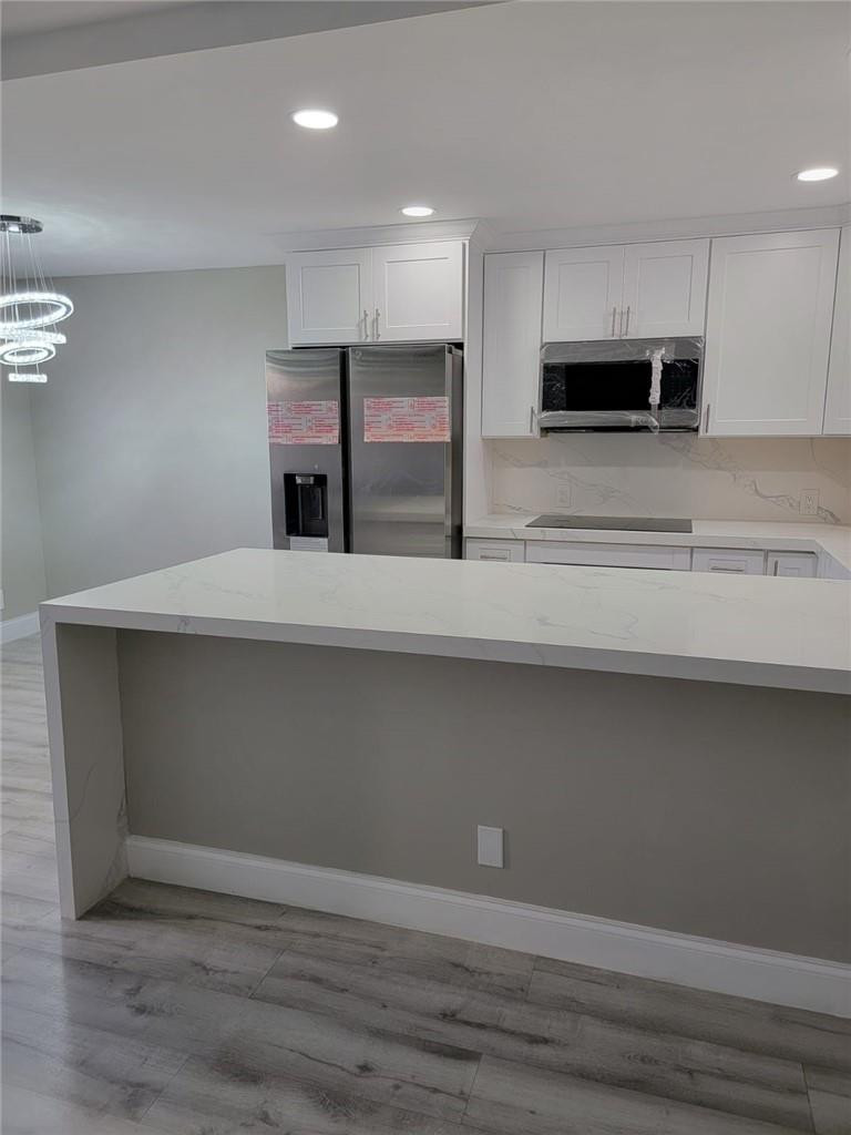296 Brighton H, Unit H Boca Raton, FL 33434 - Photo 4 of 11 a view of kitchen with stainless steel appliances cabinets