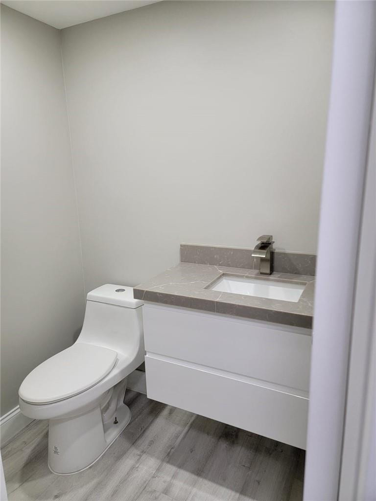 296 Brighton H, Unit H Boca Raton, FL 33434 - Photo 8 of 11 a bathroom with a toilet sink and mirror
