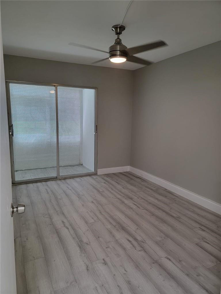 296 Brighton H, Unit H Boca Raton, FL 33434 - Photo 10 of 11 wooden floor in an empty room