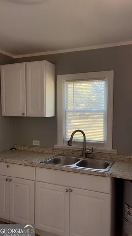 a kitchen with a sink and cabinets
