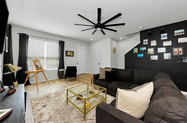 a kitchen with stainless steel appliances granite countertop a sink a stove and a refrigerator