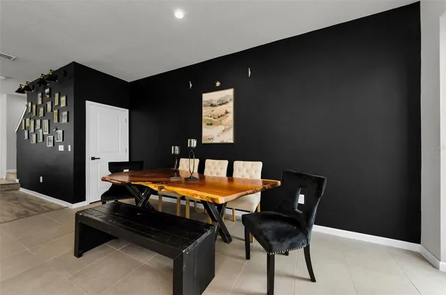 a kitchen with stainless steel appliances granite countertop a sink a stove and a wooden floor