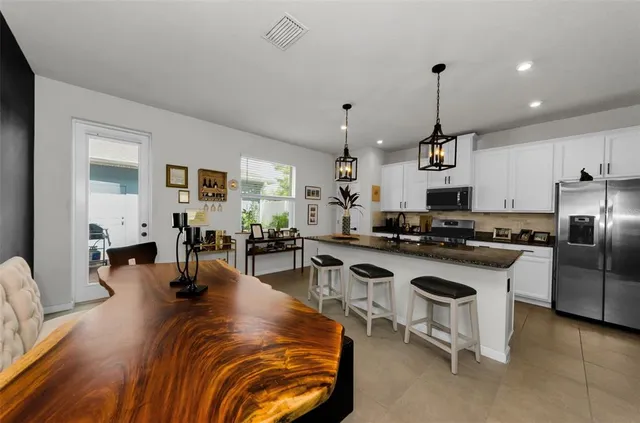 a kitchen with stainless steel appliances granite countertop a stove and a refrigerator