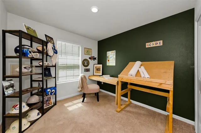 a view of a dining room and livingroom with furniture wooden floor a rug a potted plant and a chandelier