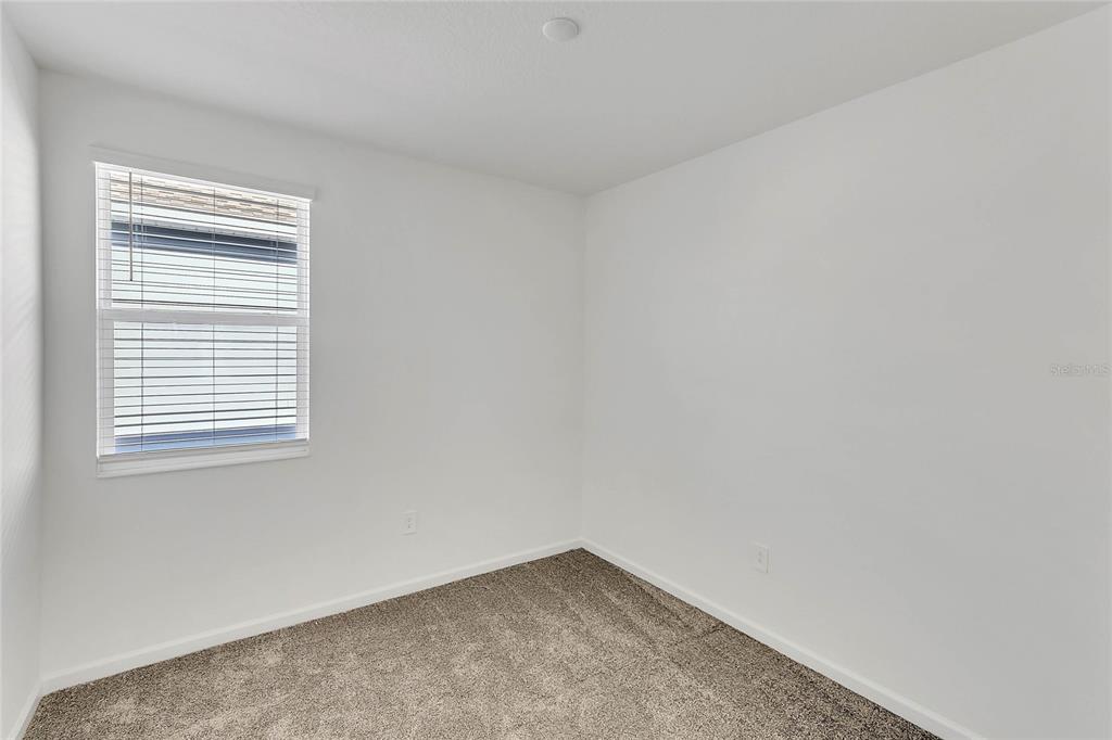 1721 Good Neighbor Loop Kissimmee, FL 34744 - Photo 15 of 28 an empty room with a window