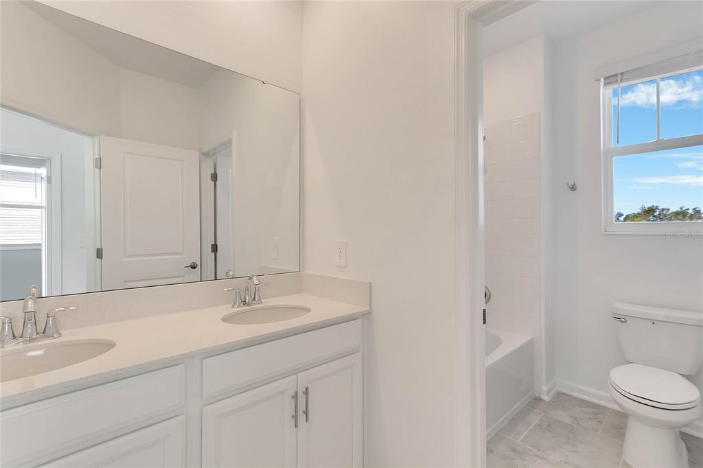 1721 Good Neighbor Loop Kissimmee, FL 34744 - Photo 17 of 28 a bathroom with 2 sink and a toilet