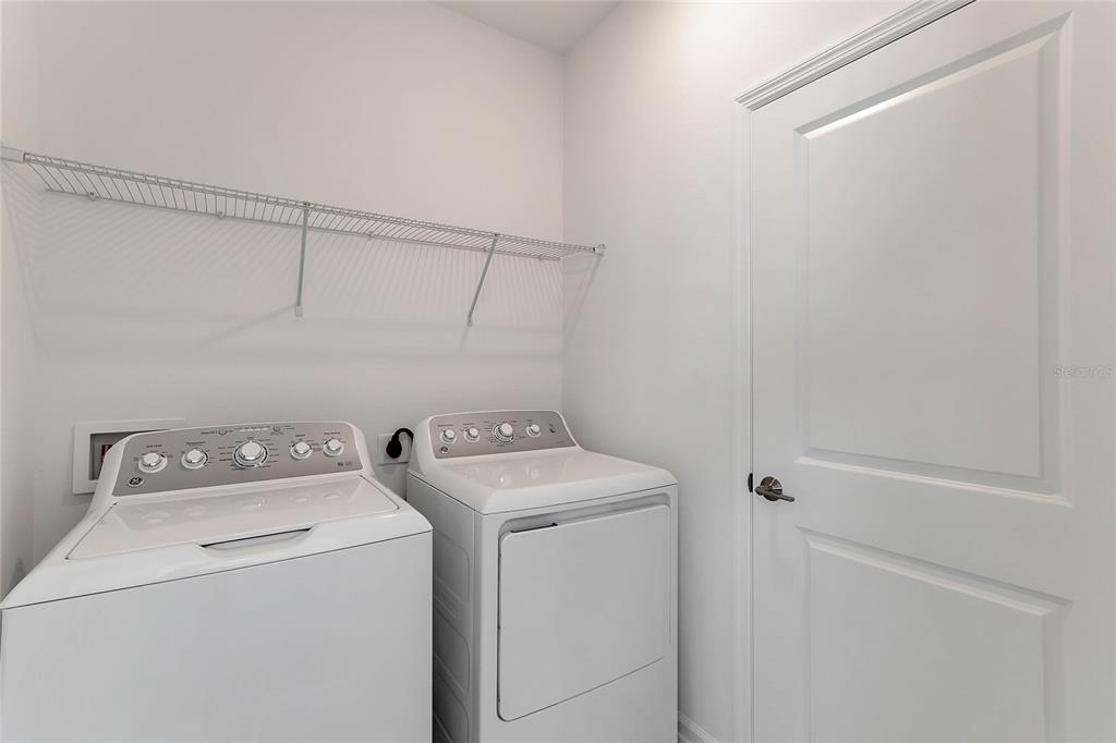 1721 Good Neighbor Loop Kissimmee, FL 34744 - Photo 18 of 28 a utility room with dryer and washer