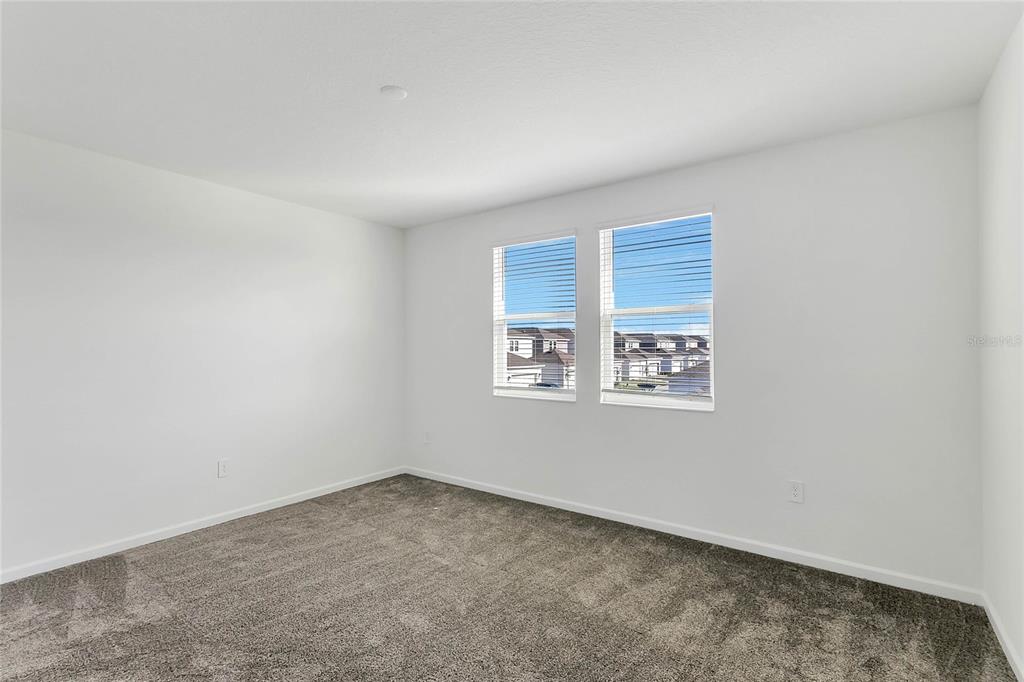 1721 Good Neighbor Loop Kissimmee, FL 34744 - Photo 20 of 28 an empty room with a window