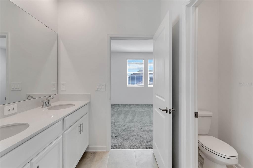 1721 Good Neighbor Loop Kissimmee, FL 34744 - Photo 23 of 28 a bathroom with a granite countertop sink toilet and shower