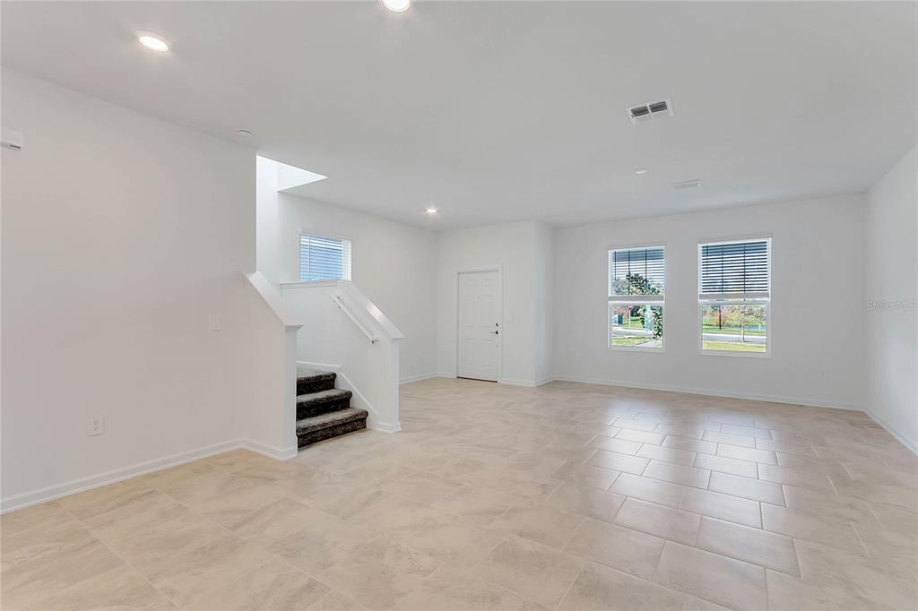 1721 Good Neighbor Loop Kissimmee, FL 34744 - Photo 3 of 28 an empty room with windows