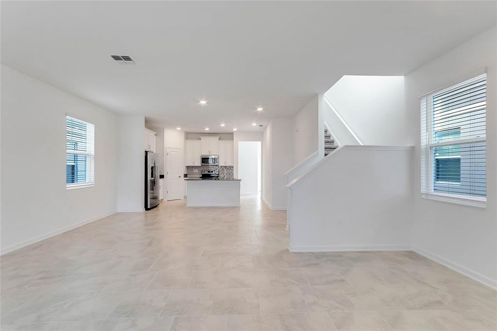 1721 Good Neighbor Loop Kissimmee, FL 34744 - Photo 4 of 28 a view of a kitchen with a refrigerator and a window