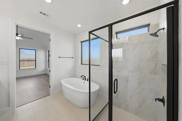 a bathroom with a bathtub and a shower