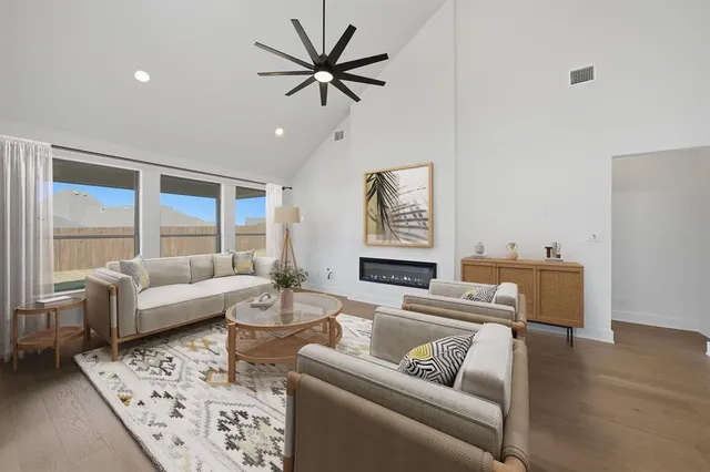 a kitchen with a dining table chairs and white cabinets