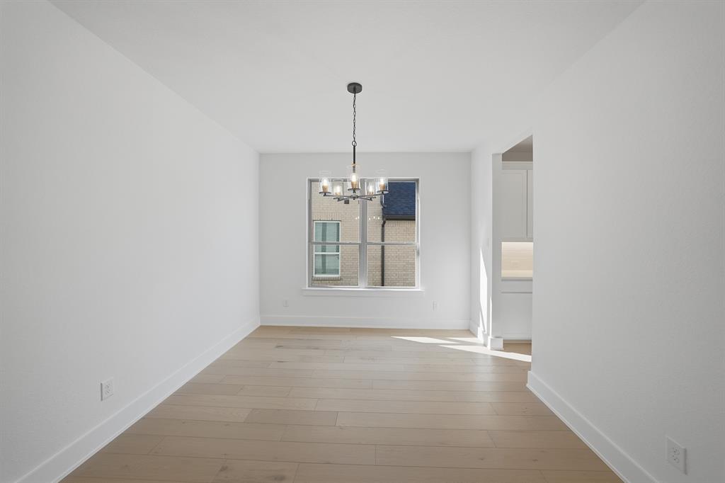 6028 Foxwheel Way Fort Worth, TX 76123 - Photo 5 of 37 Unfurnished dining area featuring a chandelier and light wood-style flooring