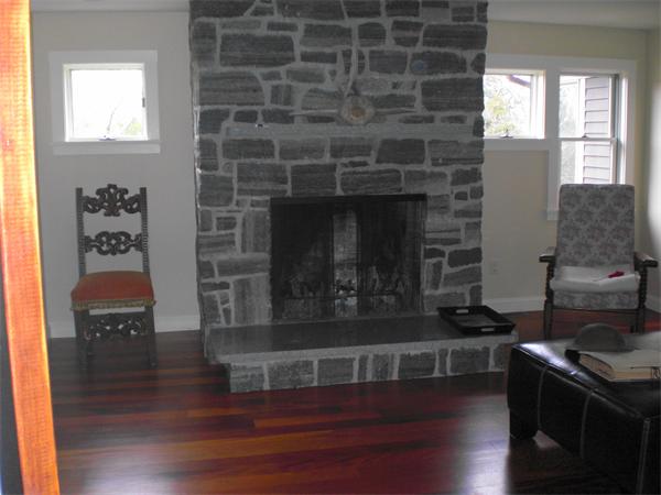 9 Bray Street Gloucester, MA 01930 - Photo 19 of 19 a kitchen with granite countertop a stove and a fireplace