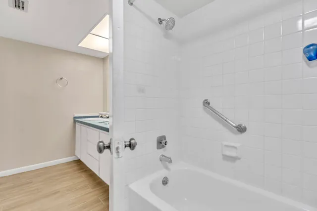 a bathroom with a bathtub and a shower