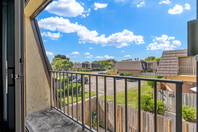 a view of a balcony with wooden floor