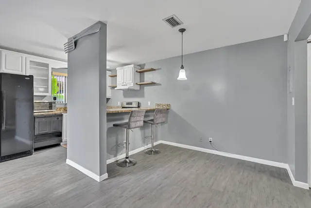 a kitchen with kitchen island a counter top space wooden floor and appliances