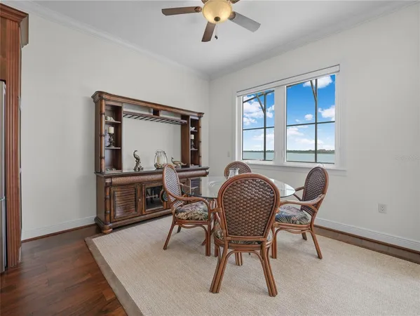 a view of an empty room with wooden floor and a cabinet