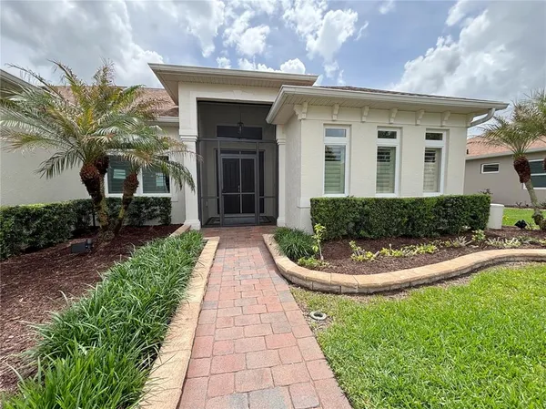 a view of a wooden house with a big yard and outdoor seating