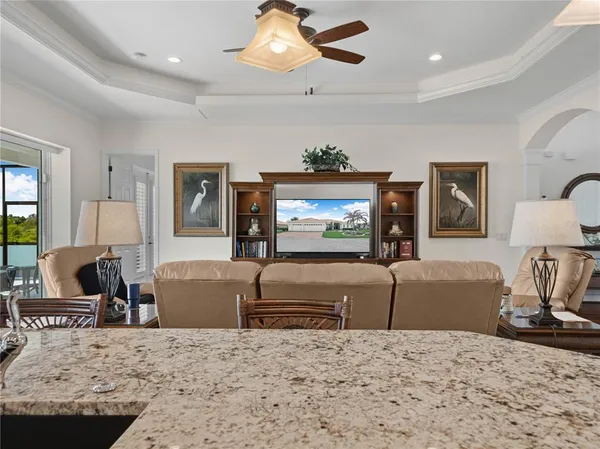 a bathroom with a granite countertop sink a toilet a mirror and shower